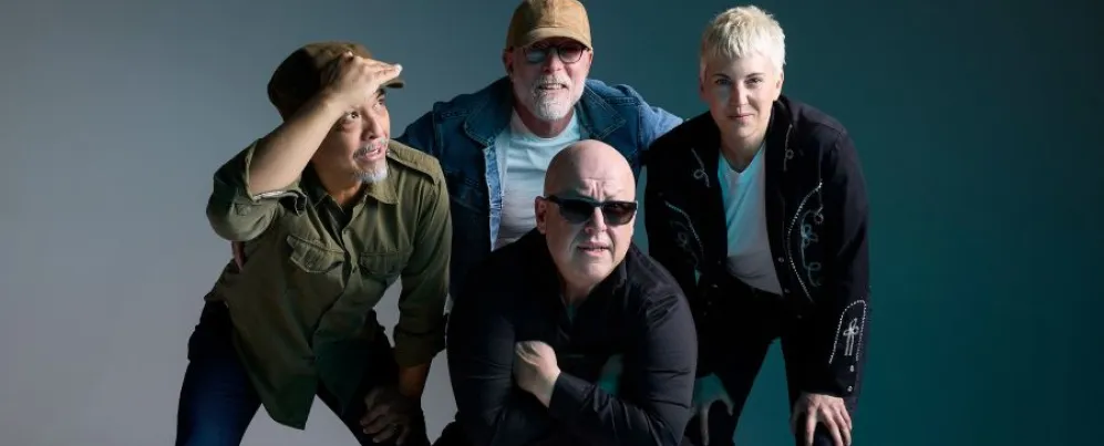 Group portrait of legendary alt-rock band PIXIES posing with casual confidence against a neutral studio backdrop.